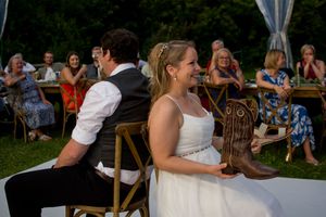 Wedding reception guests seated at outdoor tables under a sunny sky.