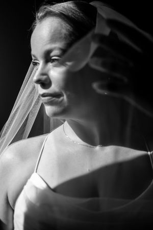 Artistic black and white close-up shots of a bride wearing a delicate veil.