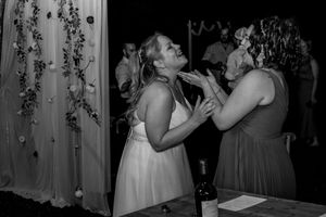 A series of black and white wedding reception photos showing couples dancing and celebrating under decorative lighting.