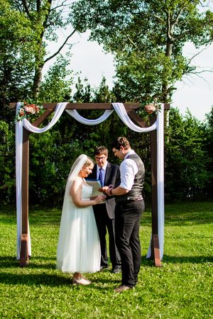 Wedding ceremony sequence showing couple exchanging vows under white draped arch in garden setting.