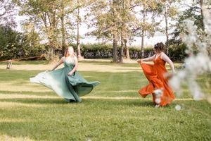 Colorful dresses flow in the breeze during an outdoor photo session.