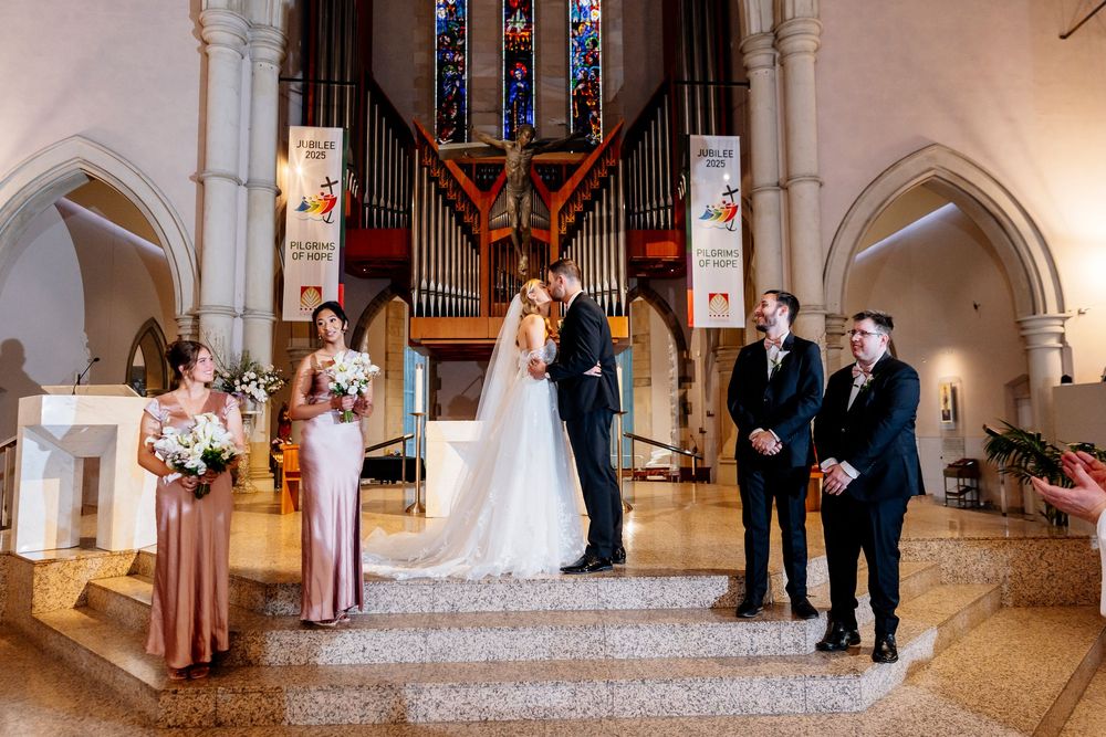 A row of wedding ceremony photos showing moments in a beautiful church with ornate architecture and stained glass windows.