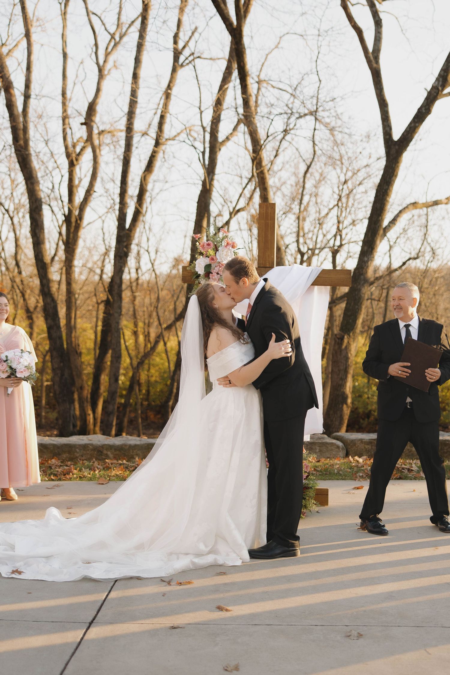 Romantic wedding ceremony photos captured in sequence with autumn trees in background.