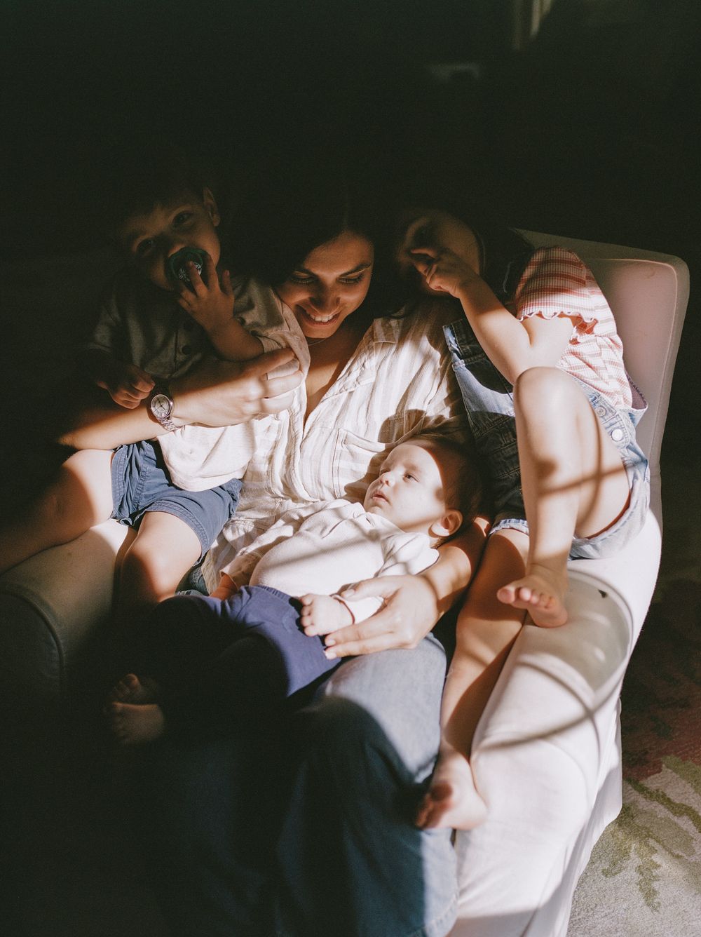Series of intimate family photographs showing quiet moments on a couch in natural light.