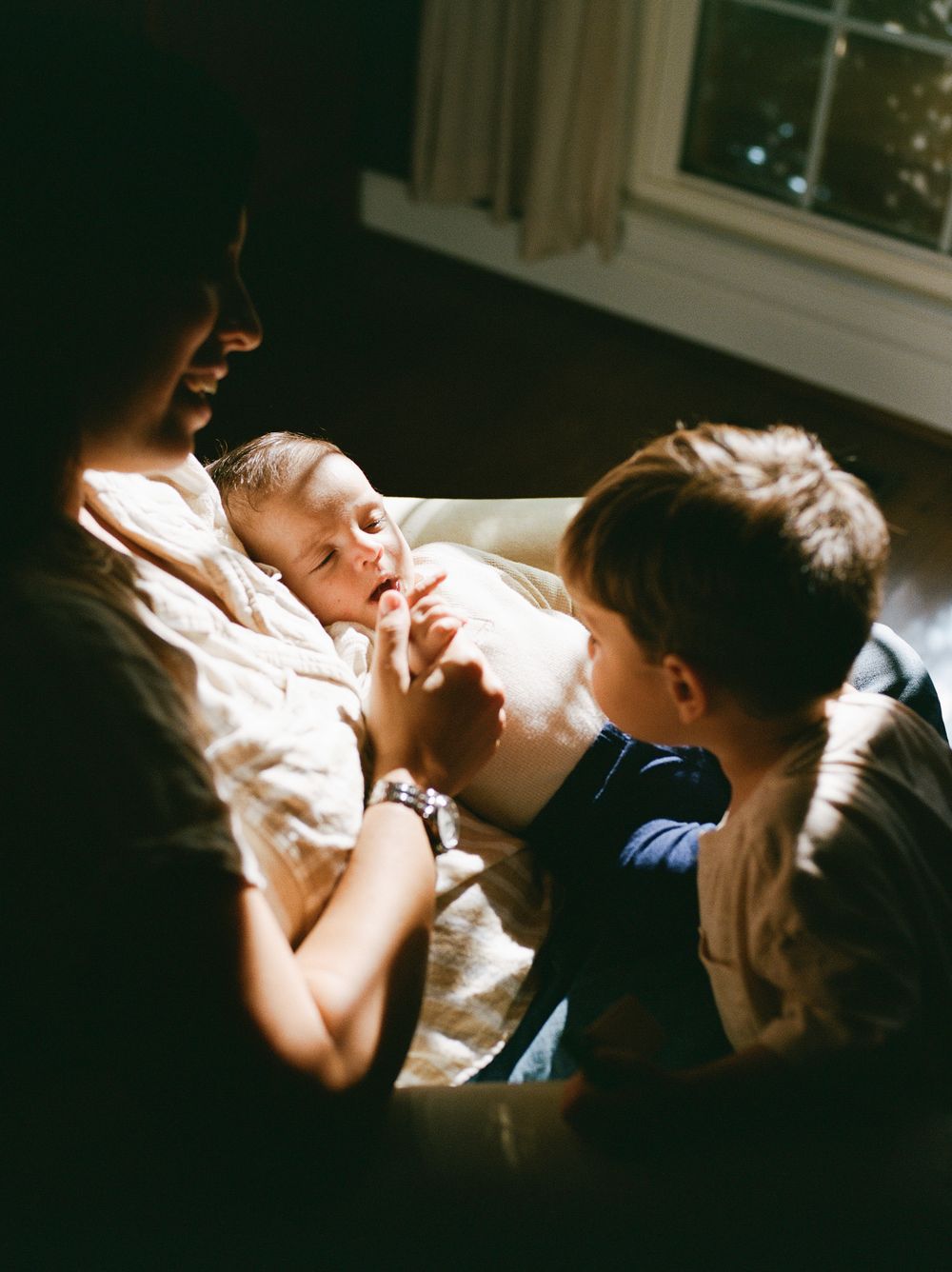Sunlit bedroom scene showing intimate family moments in a series of connected photographs.