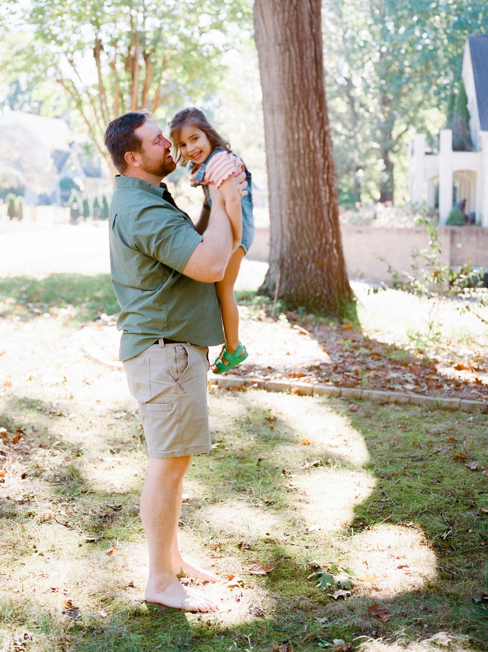 A sequence of tender outdoor moments captured in dappled sunlight beneath tall trees.