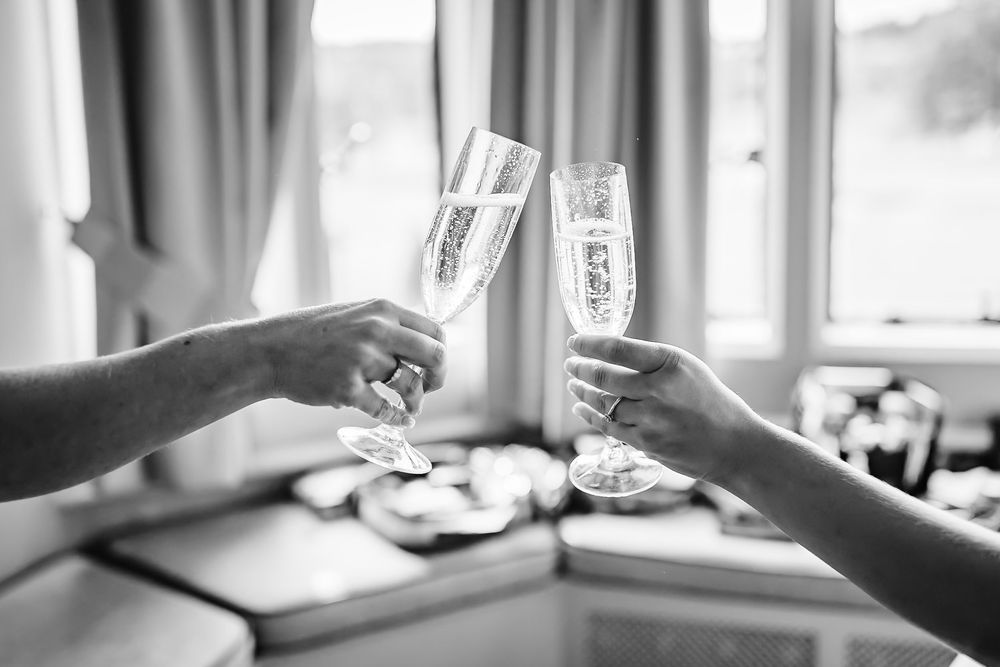 A series of black and white photographs showing wine glasses and place settings at a formal dining table.