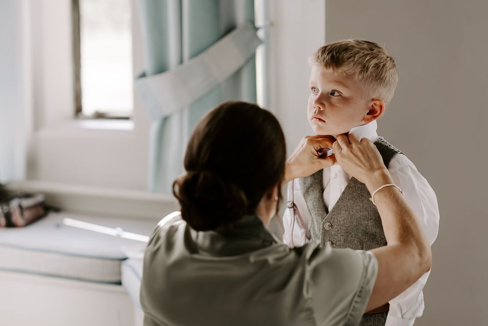 A healthcare professional examines a patient's throat during a medical checkup in a bright examination room.