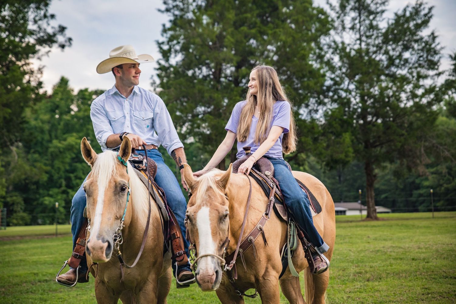 Engagement Session. Bride and Groom Riding into the sunset on horseback.