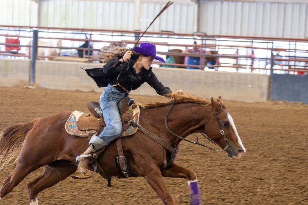 Barrel racing sequence shows rider and horse making tight turns around barrels in a rodeo arena.