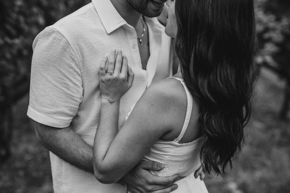 Black and white photos capturing tender moments during a vineyard proposal.