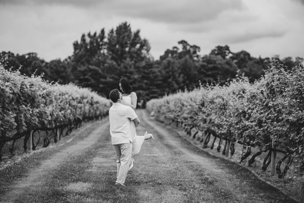 Dramatic black and white vineyard photos showing rows of grape vines during a proposal.