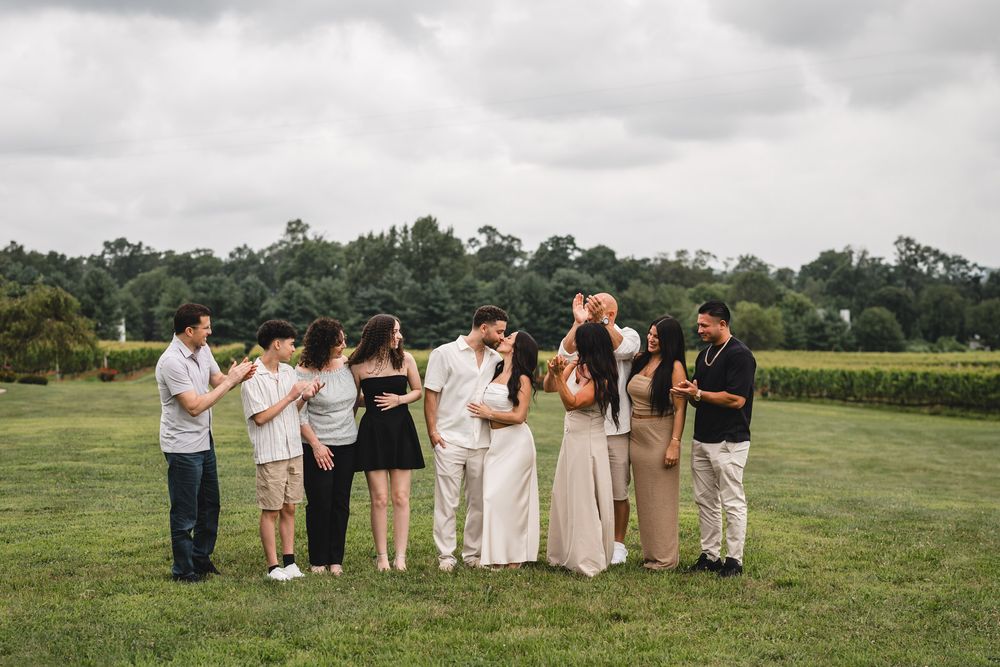 Group of people sitting together on grass at an outdoor event.