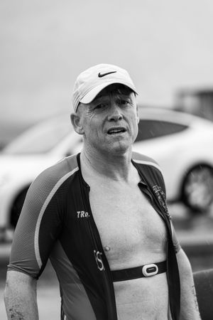 Athlete wearing Nike cap takes break during endurance competition.