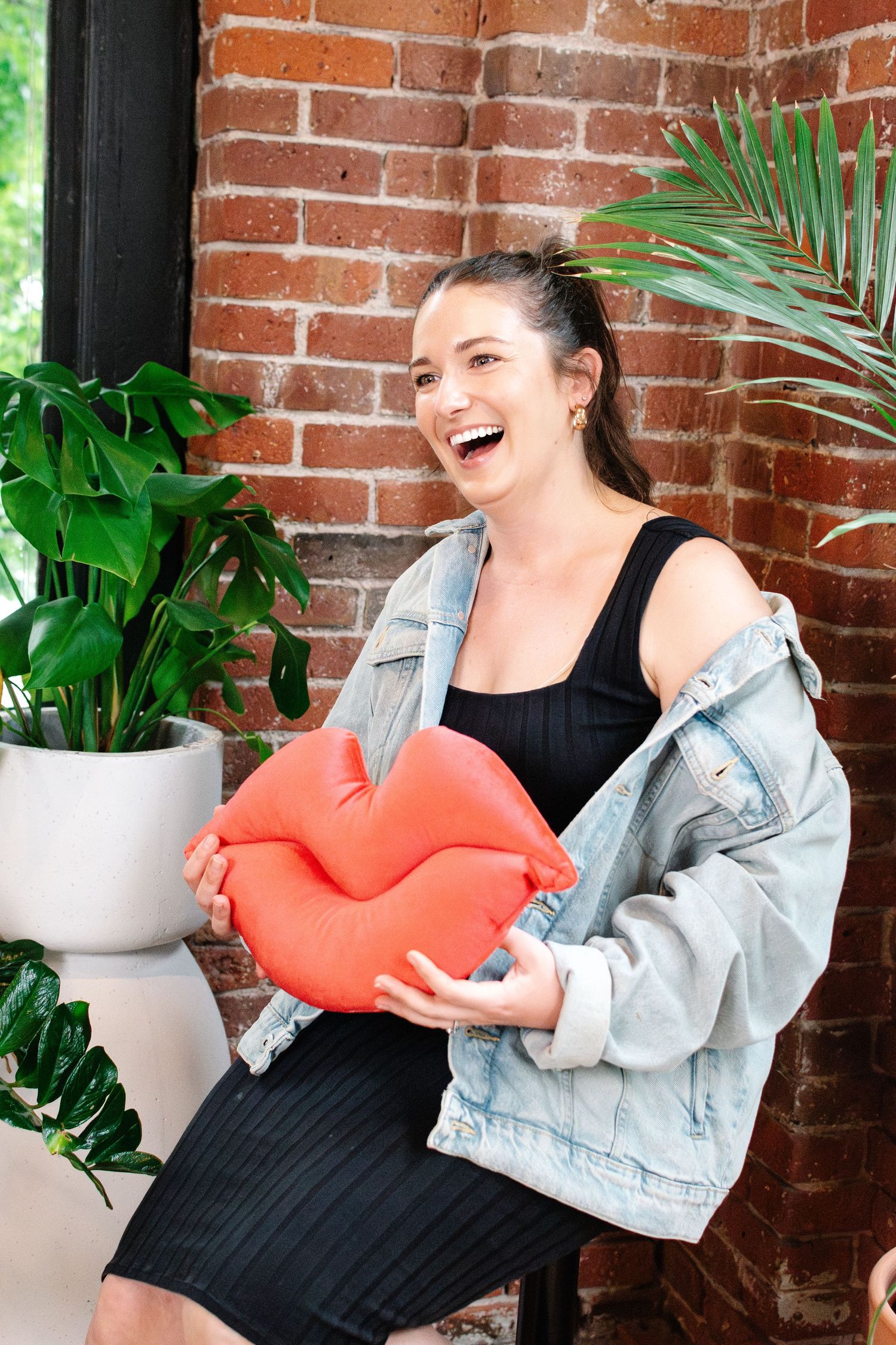 Makeup artist Rebecca Louis holding heart pillow at Seattle branding shoot