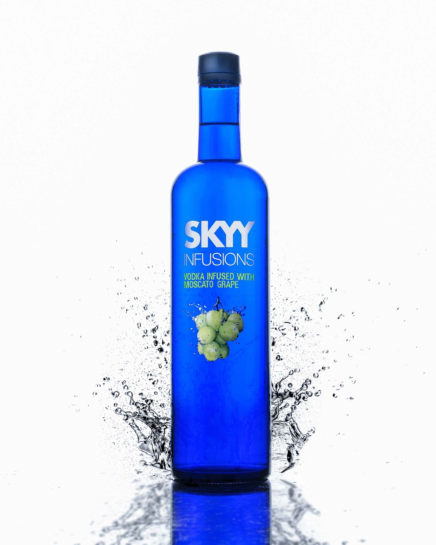 A bottle of blue Skyy Infusions grape flavored vodka with water splash effect around the base.