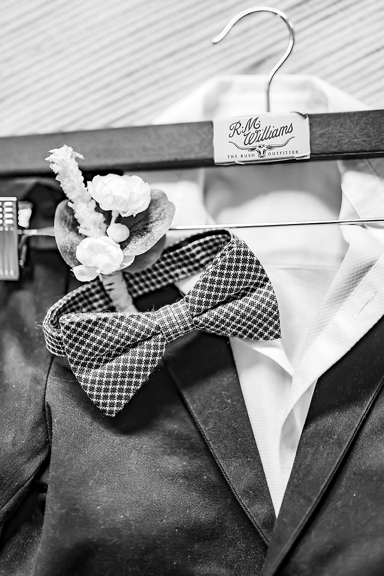 Black and white photo sequence showing the process of fastening a checkered bow tie on a formal suit.