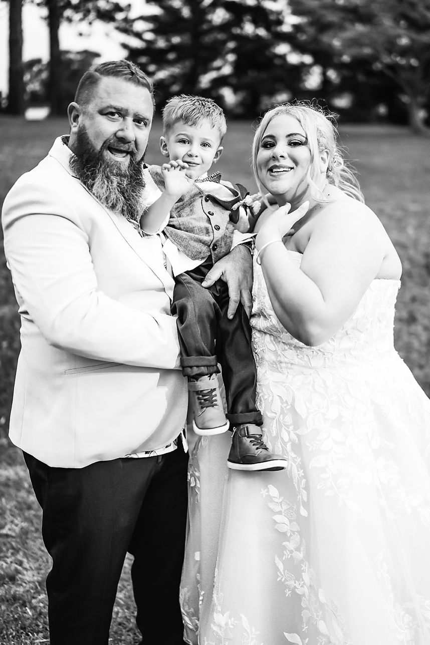 A black and white photo series captures romantic and playful moments from a couple's outdoor wedding celebration.