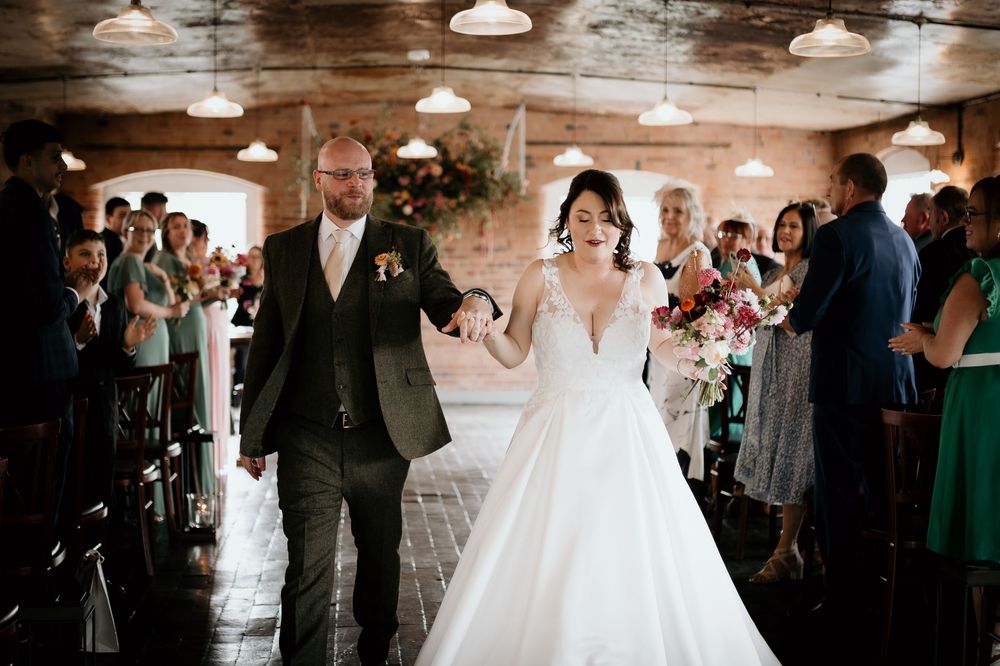 A celebration in an industrial-style venue with pendant lights and exposed brick walls.