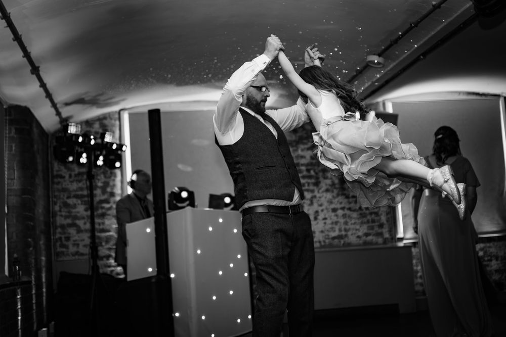 Black and white photo sequence of a couple performing a choreographed swing dance routine in a vintage-style setting.