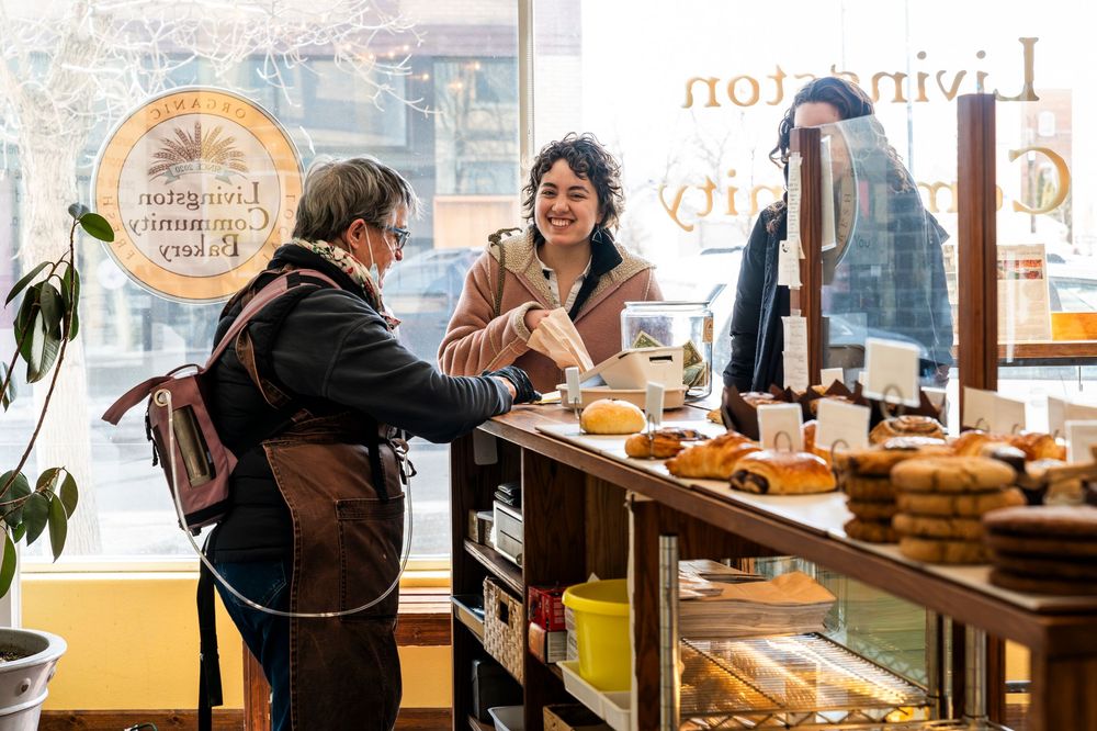 Bakery counter scene with fresh pastries and breads on display.