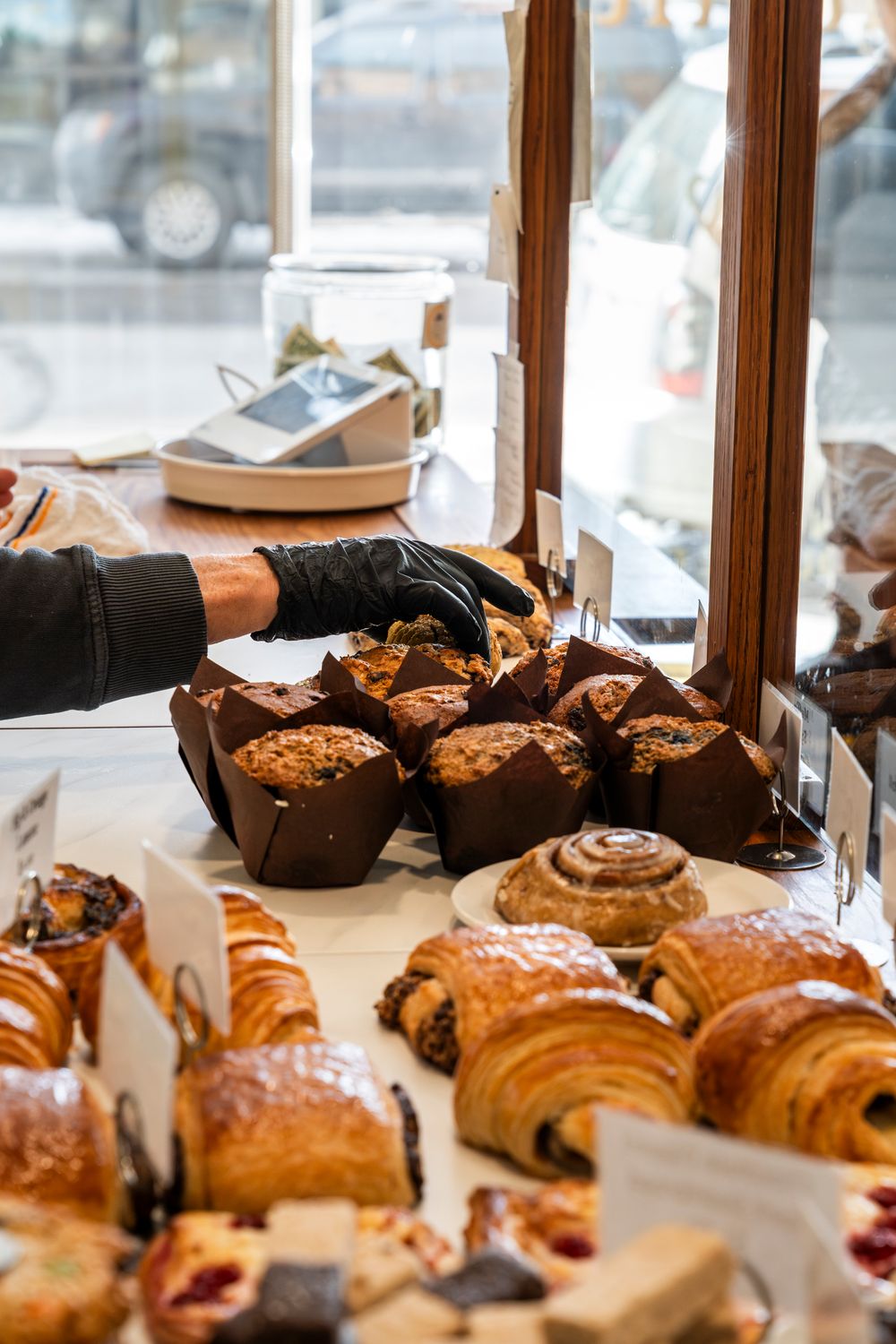 Fresh pastries and croissants arranged in a bakery display case.
