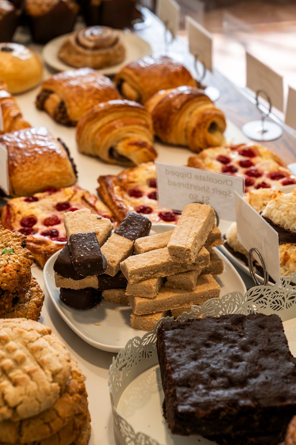 A display case filled with fresh pastries, brownies and baked goods at an upscale bakery.