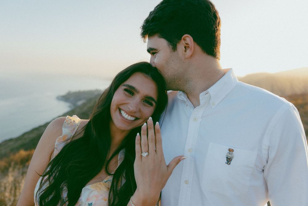 Loving couple shares romantic moments during golden hour engagement photo session at scenic outdoor location.