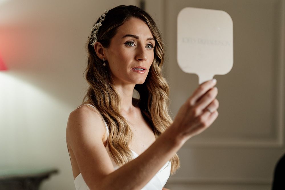 A collection of boudoir photography shots showing a bride in intimate poses against neutral backgrounds.