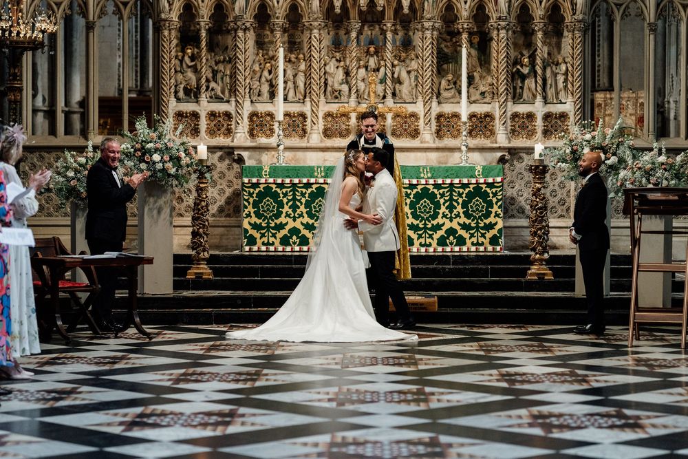 Ely Cathedral wedding ceremony with dramatic vaulted ceilings and ornate Gothic architectural details.