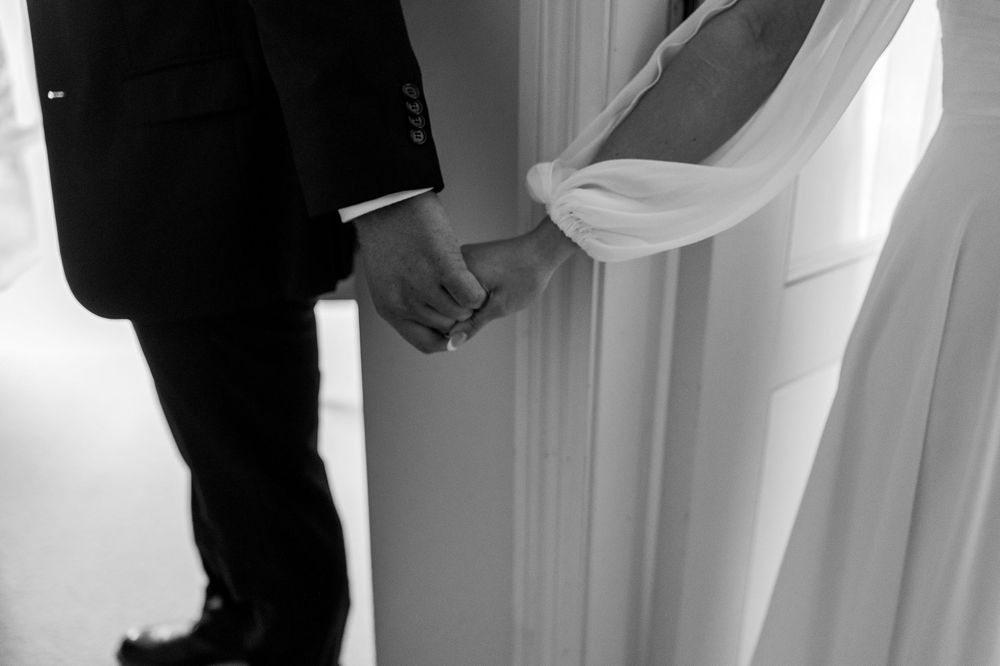 Black and white wedding detail shots showing preparations and special moments at a venue.