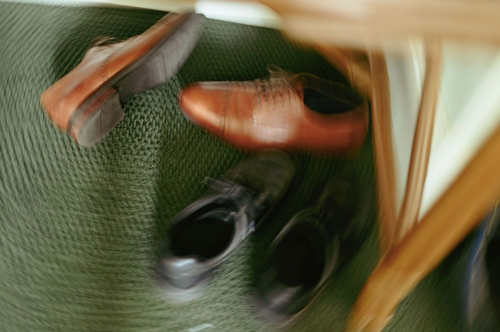A blurred motion abstract photograph with warm orange and brown tones swirling together in a dynamic pattern.