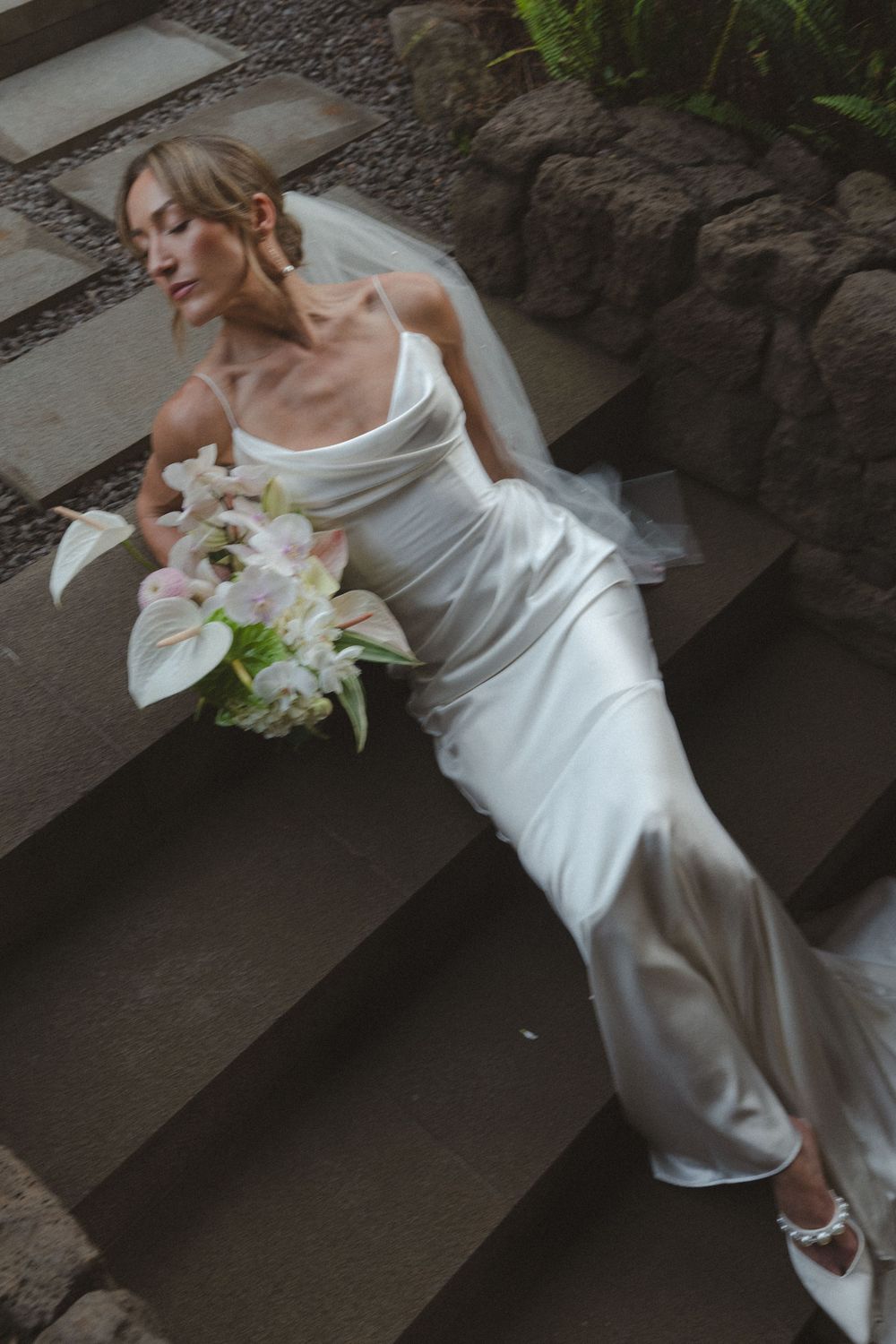 Bride laying on steps 1 Hotel Hanalei Bay