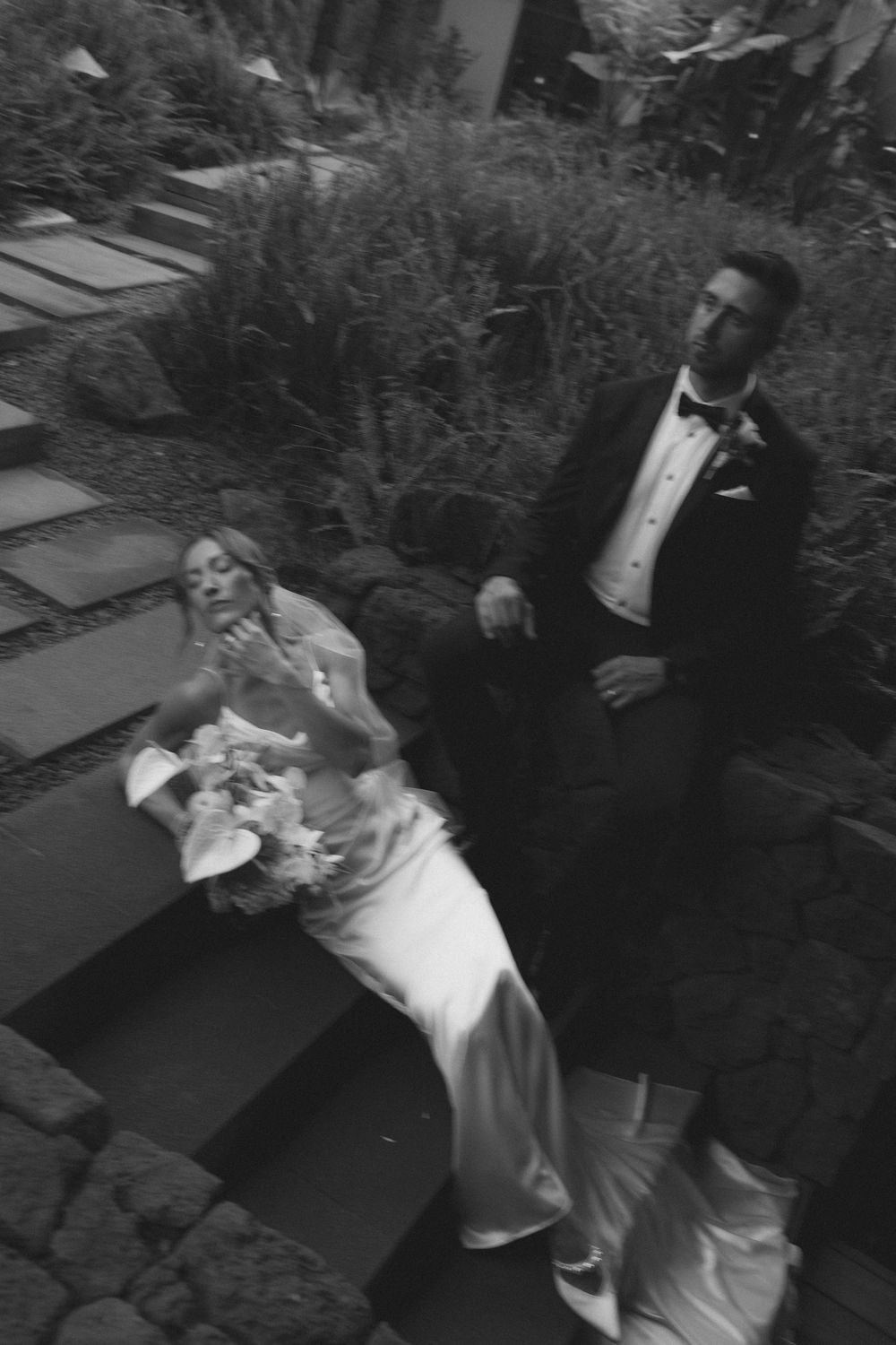 Bride and groom kissing on the steps at 1 Hotel Hanalei Bay