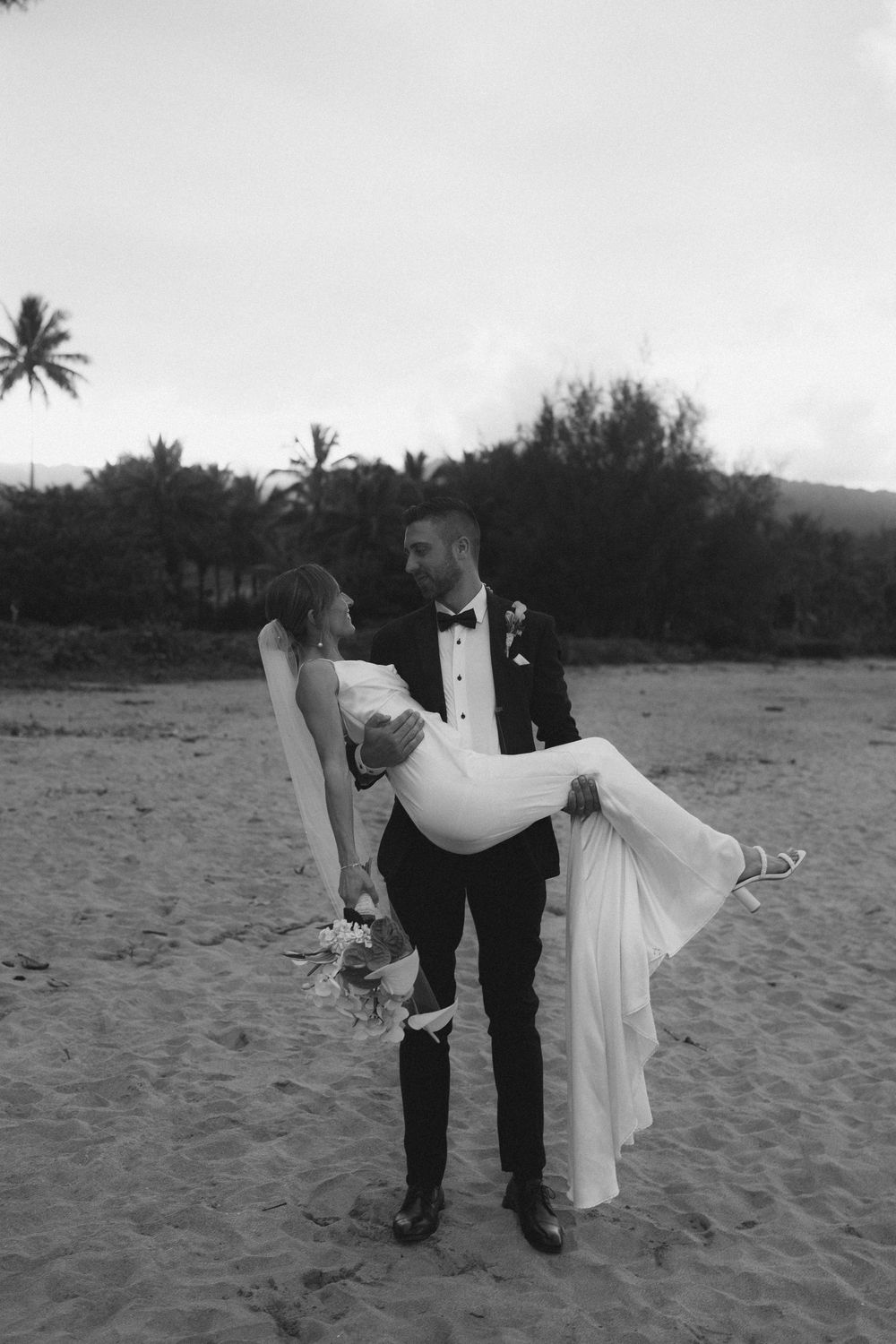 Groom holding Bride in Hanalei Bay