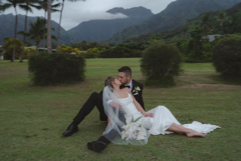 Bride and groom walking amongst the palm trees in Hanalei Bay