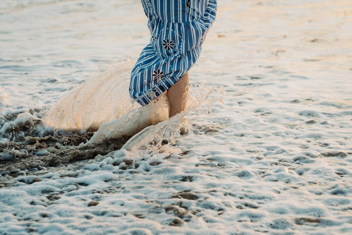 personal brand photo swap at the beach, playfully walking in water