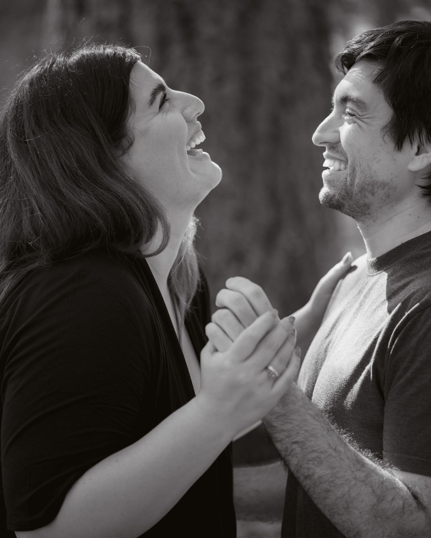 Couple laughing together at their Stanley Park engagement photo session in Vancouver