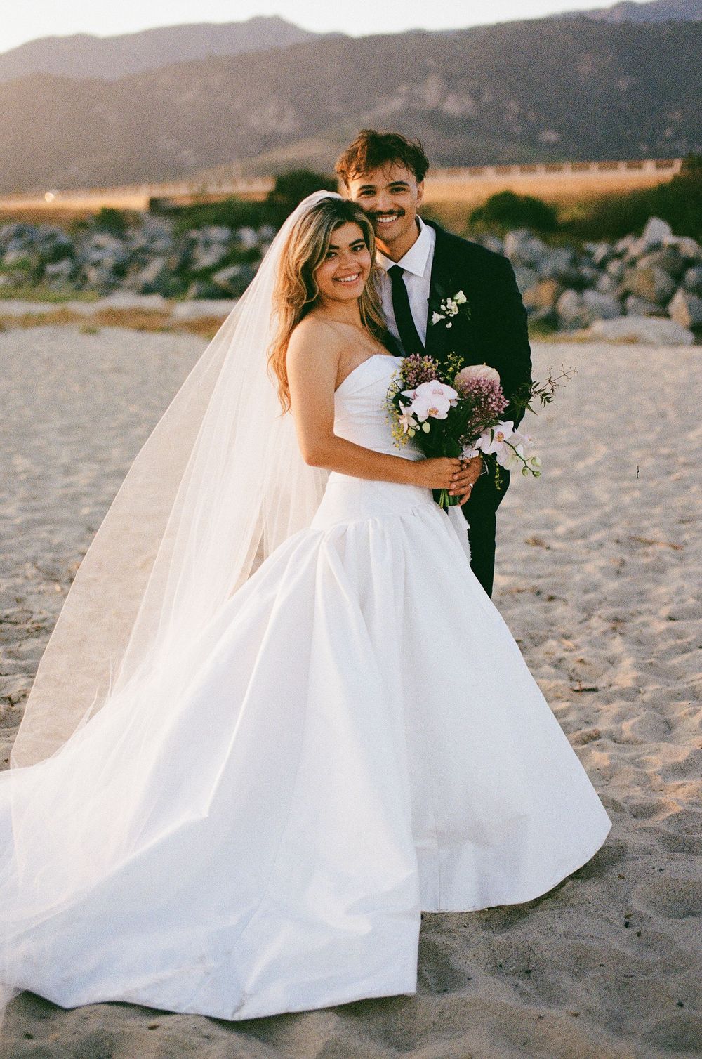 Film photo of bride and groom on the coast