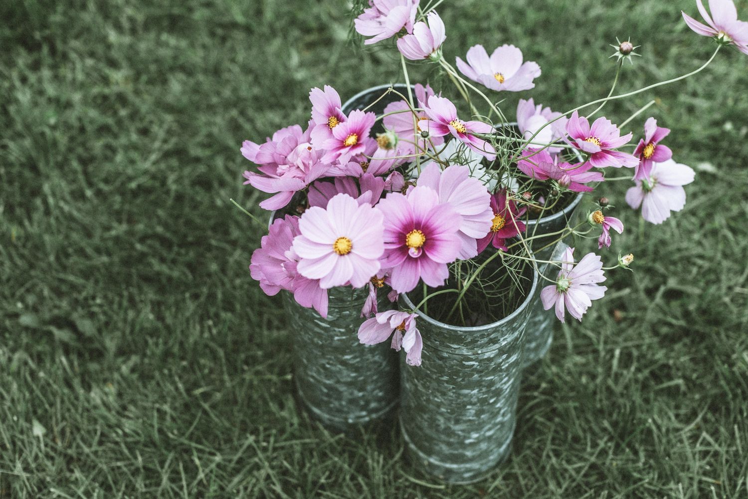 Wildflowers in aluminum vase on muted grassy field at a wedding in Grafton, Vermont. Woodstock Vermont wedding photographer