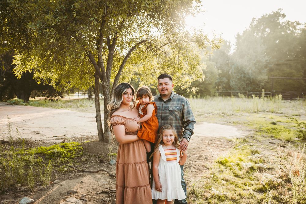 Family of four posing for a fall mini session in yucaipa ca