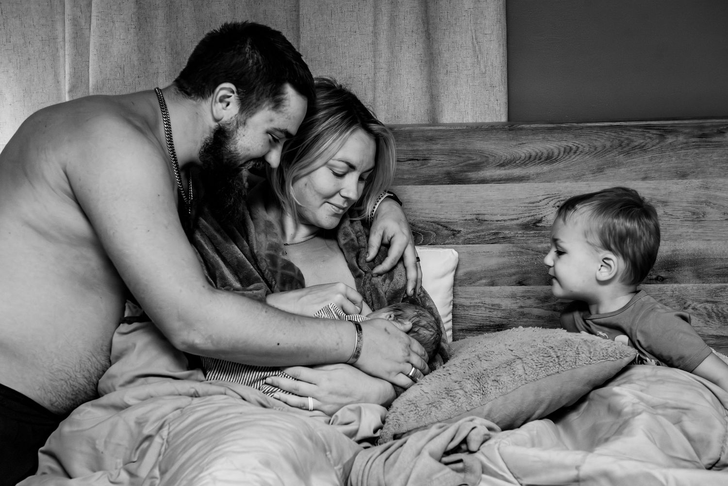 Black and white photo series showing tender moments between parent and child lying together on bed.