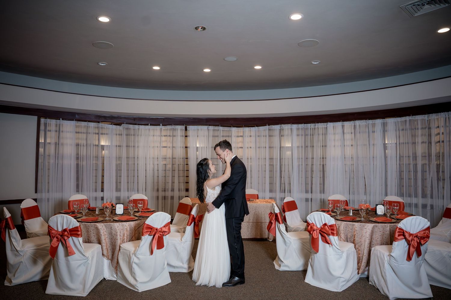 Bride & groom in the reception hall of Yolo Fliers Club in Woodland, Calif. Photo by Ashley Nicole Baeza, Woodland wedding photographer.
