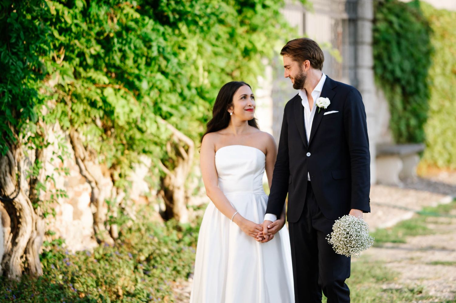 A bride and groom share a romantic moment outdoors at wedding in luxury villa in Verona, Valpolicella