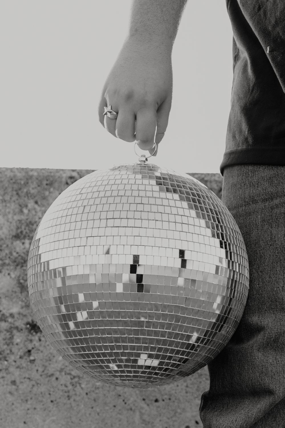Close-up of hand touching mirror disco ball in monochrome.  - Dayton, Ohio