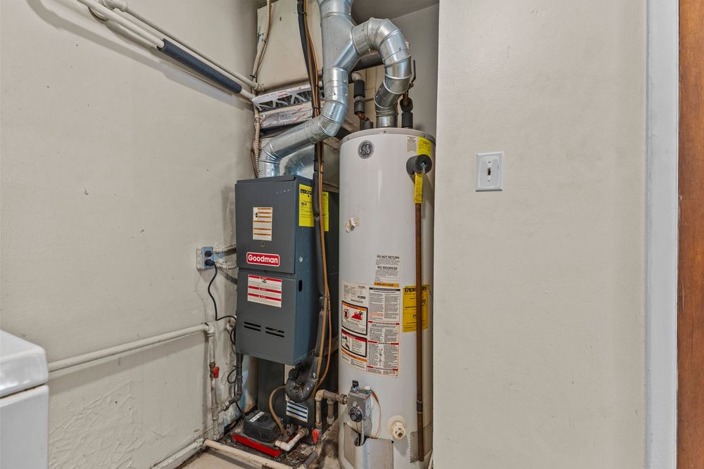 Utility room with furnace and water heater installation.
