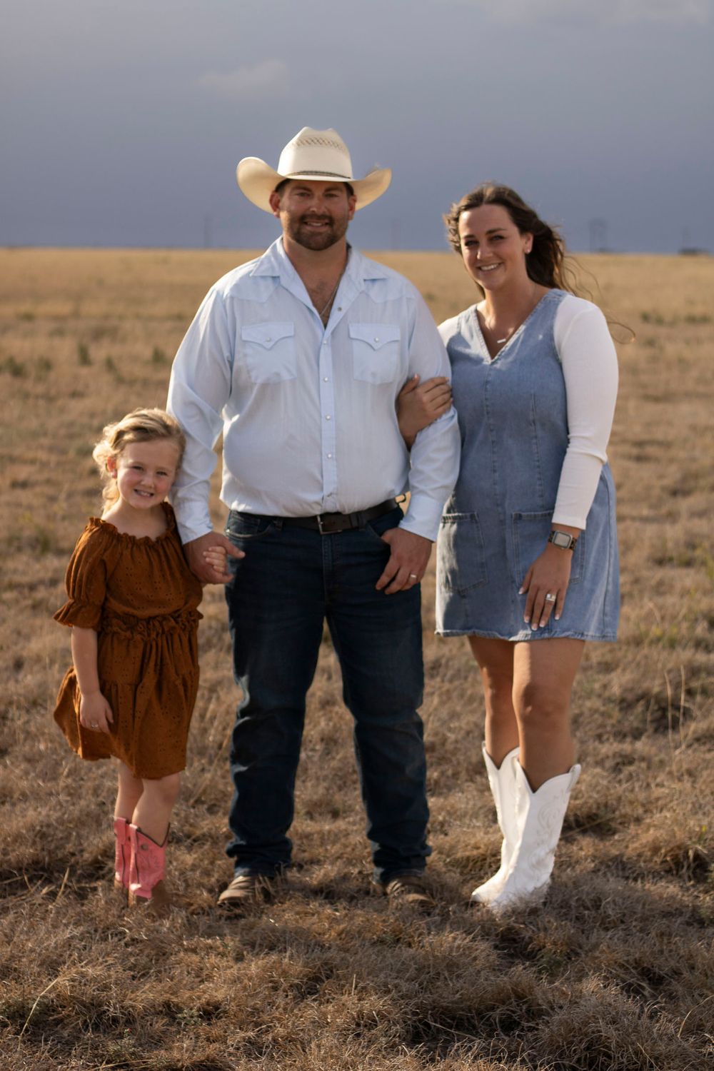 A family of three during a family photo session at an open field in Amarillo, Texas