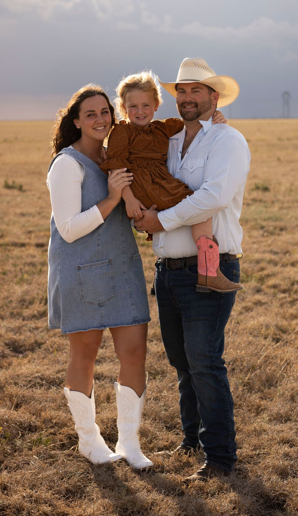 A family of three during a family photo session at an open field in Amarillo, Texas