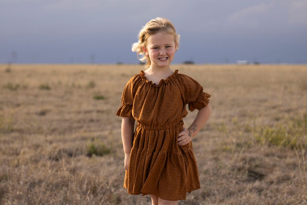 A young girl during a family photo session at an open field in Amarillo, Texas