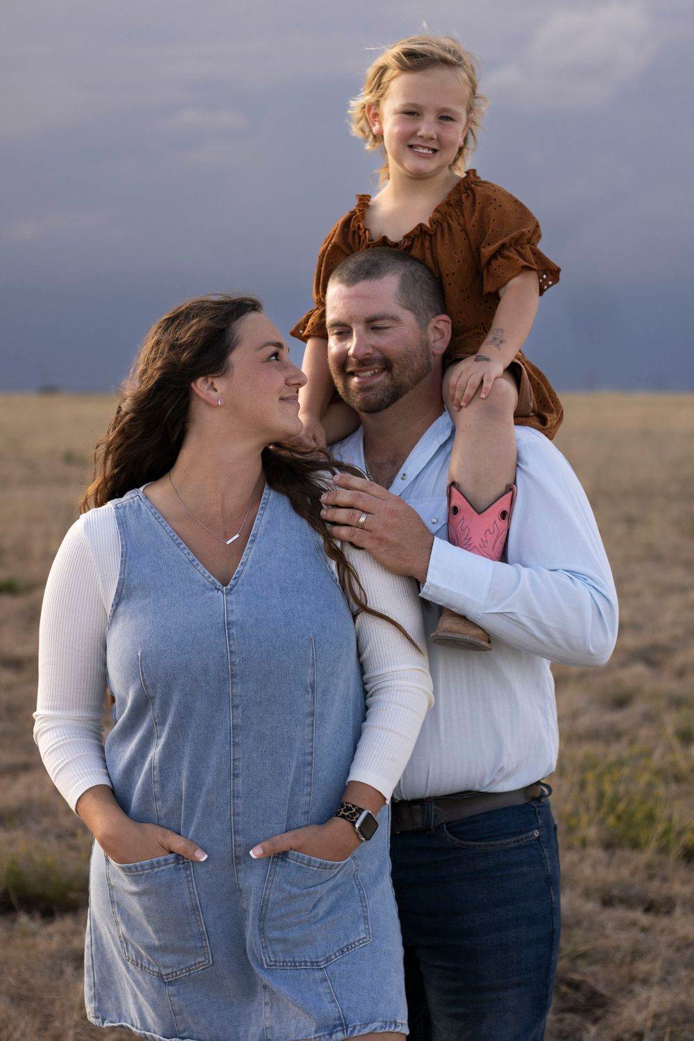A family of three during a family photo session at an open field in Amarillo, Texas